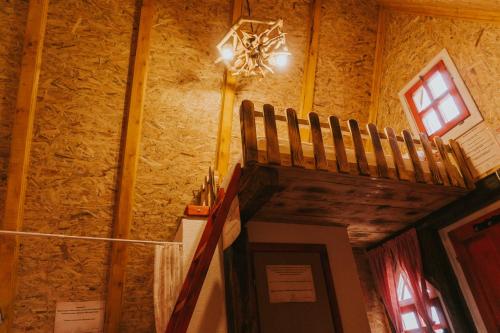 a room with a stone wall and a chandelier at Etno Village Dolina Sreće in Vitez