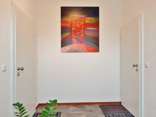 a painting hanging on a wall with two doors at Lausitzer Ferienapartments in Bernsdorf
