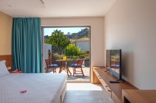 a bedroom with a bed and a view of a patio at On Oda Oludeniz in Oludeniz