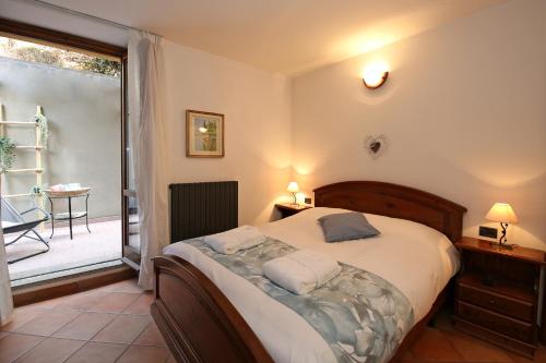 a bedroom with a large bed and a balcony at Mella Bellagio Al Porto - Apartment with terraces near the Lake - Parking in Bellagio