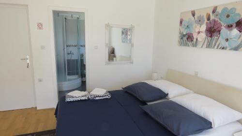 a bedroom with a bed and a mirror at Rooms Kasalo in Split