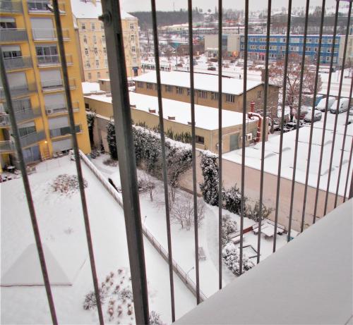 a view from the balcony of a building in the snow at soukromý pokoj in Prague