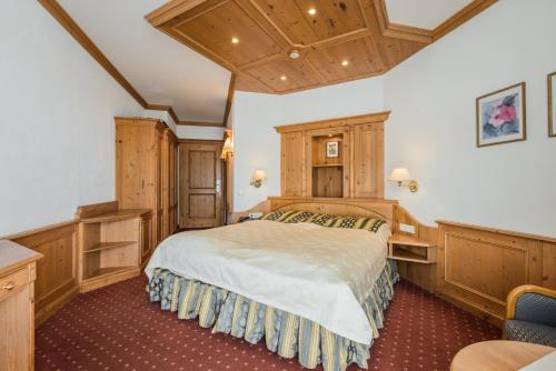 a bedroom with a bed and wooden cabinets at Alte Schmiede Hiltpolt in Seefeld in Tirol