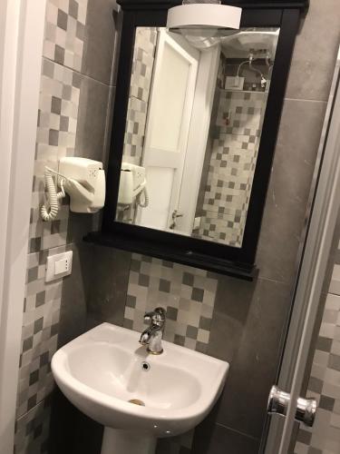 a bathroom with a sink and a mirror at Guest House Bracciano RM in Bracciano