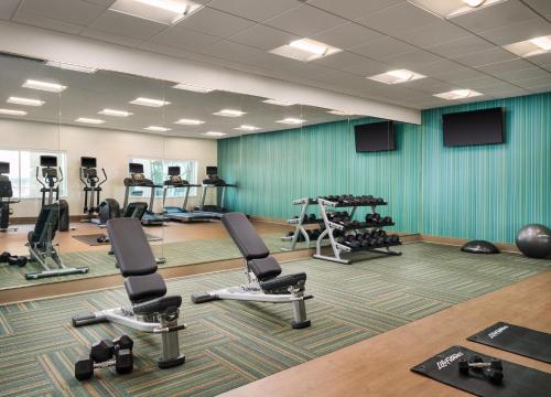 a gym with several treadmills and exercise equipment at Holiday Inn Express & Suites - Lockport by IHG in Lockport