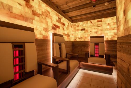 a spa room with two mirrors and two chairs at Alte Schmiede Hiltpolt in Seefeld in Tirol