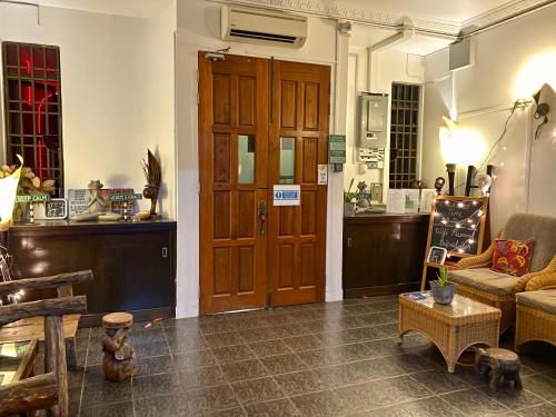a living room with a large wooden door and a couch at Ardour Lodge "B" Wing in George Town