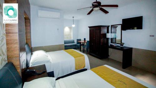 Ένα ή περισσότερα κρεβάτια σε δωμάτιο στο Hotel Maioris La Paz