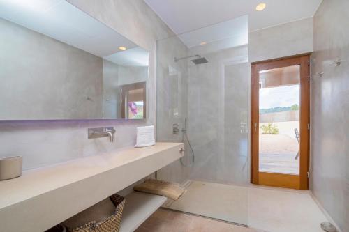 a bathroom with a sink and a mirror at Villa Can Ginebra in Sant Josep de Sa Talaia