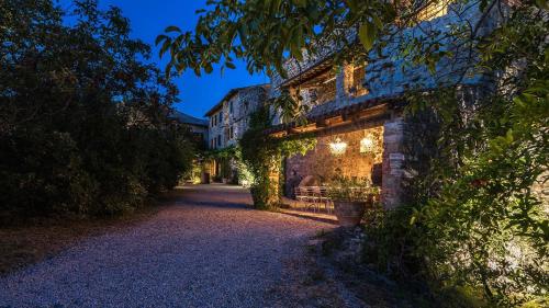 a building with ivy on the side of a road at CONTESSA MATILDE 16, Emma Villas in Collazzone