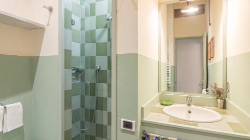 a bathroom with a sink and a mirror at CONTESSA MATILDE 16, Emma Villas in Collazzone