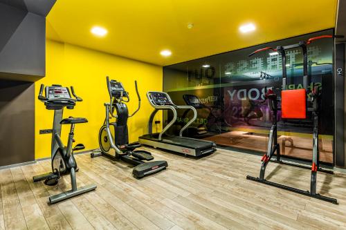 a gym with treadmills and exercise bikes in a room at Hotel Urban in Plovdiv