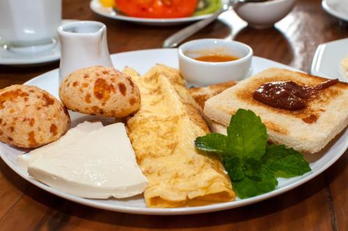 a plate of breakfast food with eggs and toast at Pousada Richard Rothe in Tiradentes
