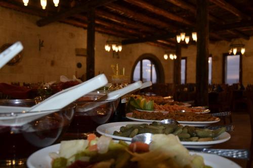 a buffet line with plates of food on a table at Cappa Villa Cave Hotel & Spa in Ürgüp