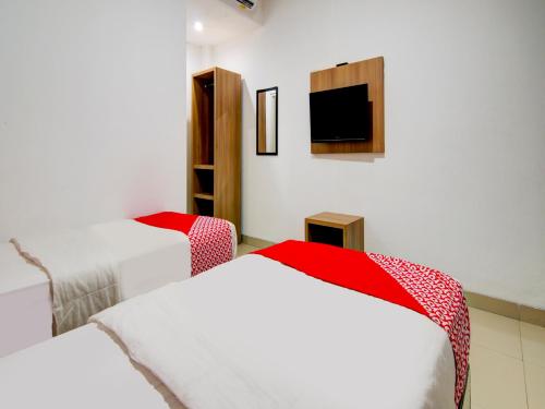 Ένα ή περισσότερα κρεβάτια σε δωμάτιο στο OYO 90233 The Shine Residence