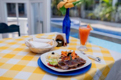 a plate of food on a table with a plate of food at Hotel Casona del Lago in Flores