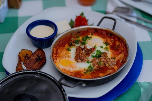 a dish of food on a plate on a table at Hotel Casona del Lago in Flores
