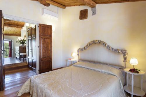 a bedroom with a bed in a room with wooden ceilings at Villa La Poiana 10 Emma Villas in Radda in Chianti
