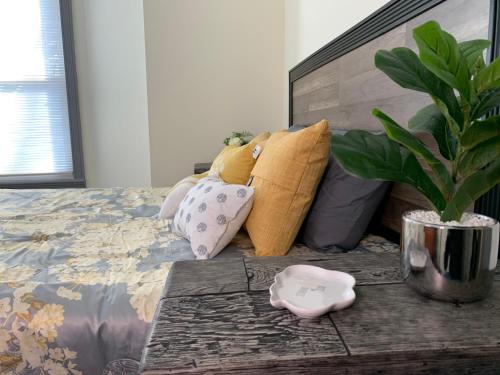 a bedroom with a bed with pillows and a potted plant at Perfect 6BR Stay Near Falls & Attractions in Niagara Falls