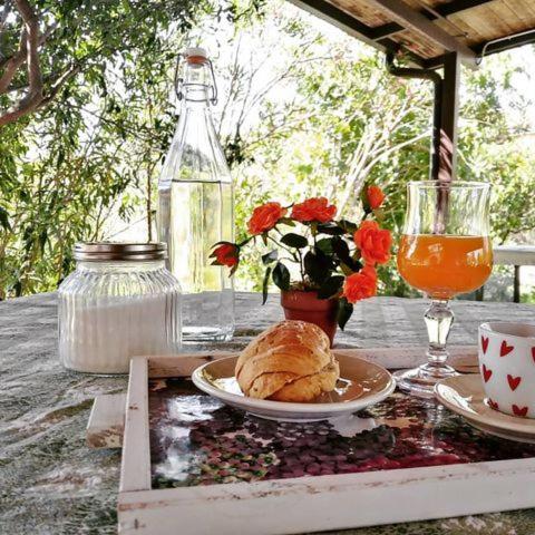 a table with a plate of food and a drink at Punto Verde B&B in Ardore Marina