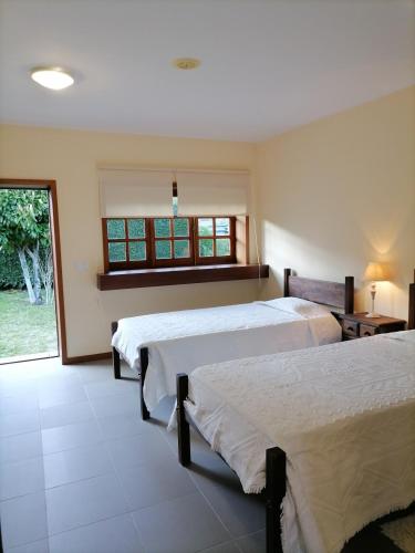 a bedroom with two beds and a window at Quinta Do Fijo in Arcos de Valdevez