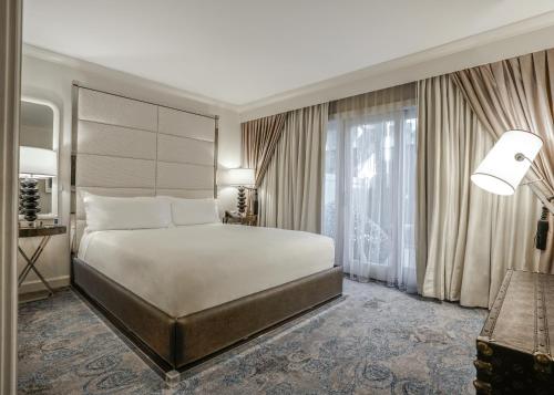 a bedroom with a large bed and a large window at Hotel Amarano Burbank-Hollywood in Burbank