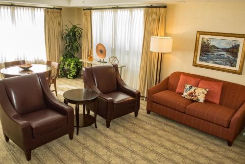 a hotel room with a couch and chairs and a table at The Inn at Virginia Tech - On Campus in Blacksburg