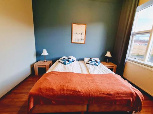 a bedroom with a bed with two pillows on it at Hlín Guesthouse in Varmahlid