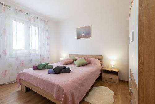 a bedroom with a bed with two pillows on it at Apartment Little Gallery **** in Rovinj