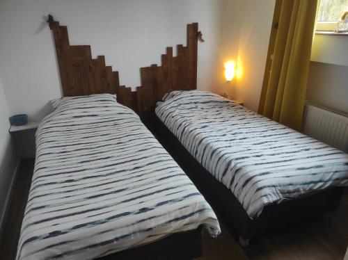 two beds sitting next to each other in a room at Studio Red Kot in Zielona Góra