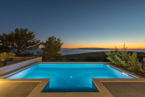 a swimming pool in the backyard of a house at Villa Kuk with heated salt water pool - Makarska in Makarska