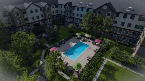 an aerial view of a building with a swimming pool at Staybridge Suites Houston West - Energy Corridor, an IHG Hotel in Houston