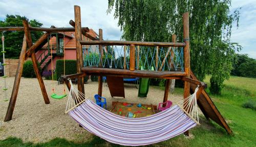 a hammock in a park with a playground at Penzion Na Lednické in Hlohovec