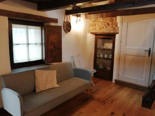 a living room with a couch and a door at B&B e Home Restaurant S'ispera Monolocale uso esclusivo in Fonni