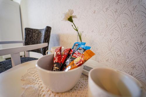 a bowl of snacks on a table with a vase at Salaš Isailovi in Sremska Mitrovica