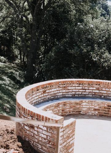 a brick retaining wall around a swimming pool at The Living Collective Villa in Hilton