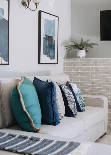 a living room with a couch with pillows on it at The Living Collective Villa in Hilton