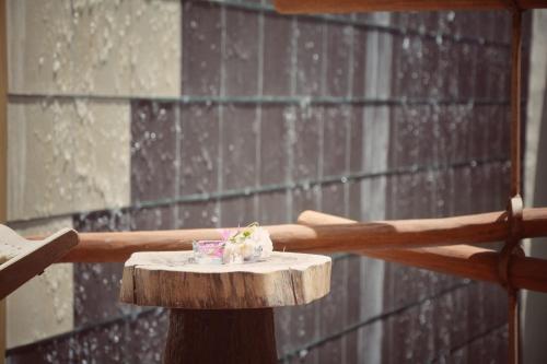 a wooden table with a cup on top of it at Kinbe Hotel Boutique in Playa del Carmen