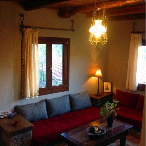 a living room with a couch and a table at Oikies Katogi in Pramanta