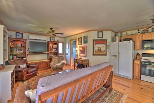 a living room with a bench and a refrigerator at Waterside Belhaven House and Cottage with Porch and Dock in Belhaven