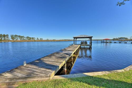 a dock with a gazebo on a lake at Waterside Belhaven House and Cottage with Porch and Dock in Belhaven