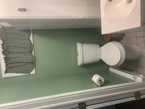 a paper towel dispenser on the wall of a bathroom at Green Mountain Cabins in Killington