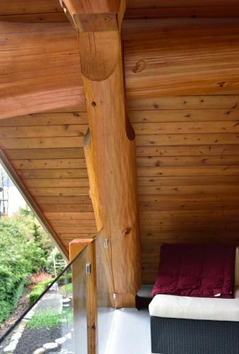 a wooden attic with a bed in a room at The Rockwell-Harrison Guest Lodge in Harrison Hot Springs