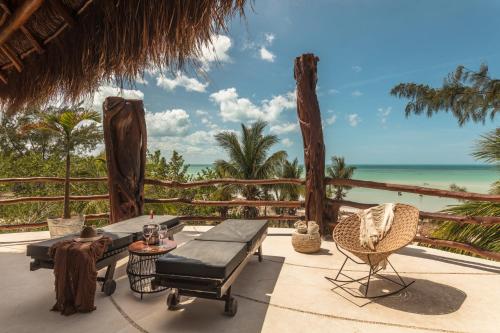 a patio with a view of the ocean at Hotel Villas Flamingos in Holbox Island