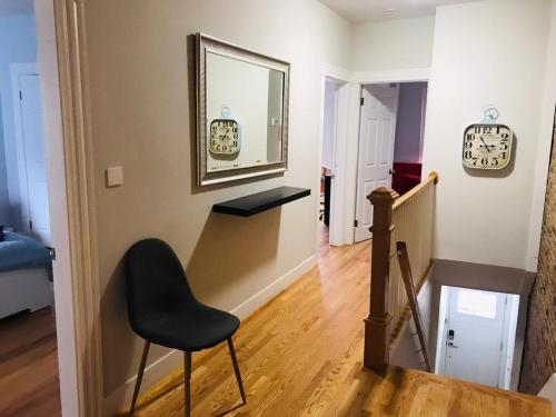 a stairway with a chair and a mirror at Renovated, 10 Min from the city in Boston
