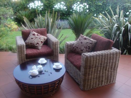 two chairs and a coffee table on a patio at Lucky Bean Guesthouse in Johannesburg