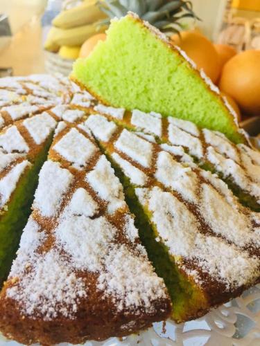 a piece of cake with powdered sugar on top of it at Hotel Montmartre in Rimini
