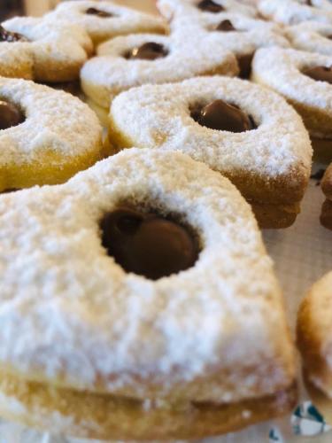 a bunch of donuts with powdered sugar on them at Hotel Montmartre in Rimini