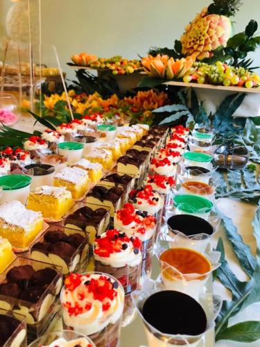 a table with many different types of cakes and desserts at Hotel Montmartre in Rimini