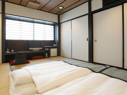 Postelja oz. postelje v sobi nastanitve My Hotel Ryugu